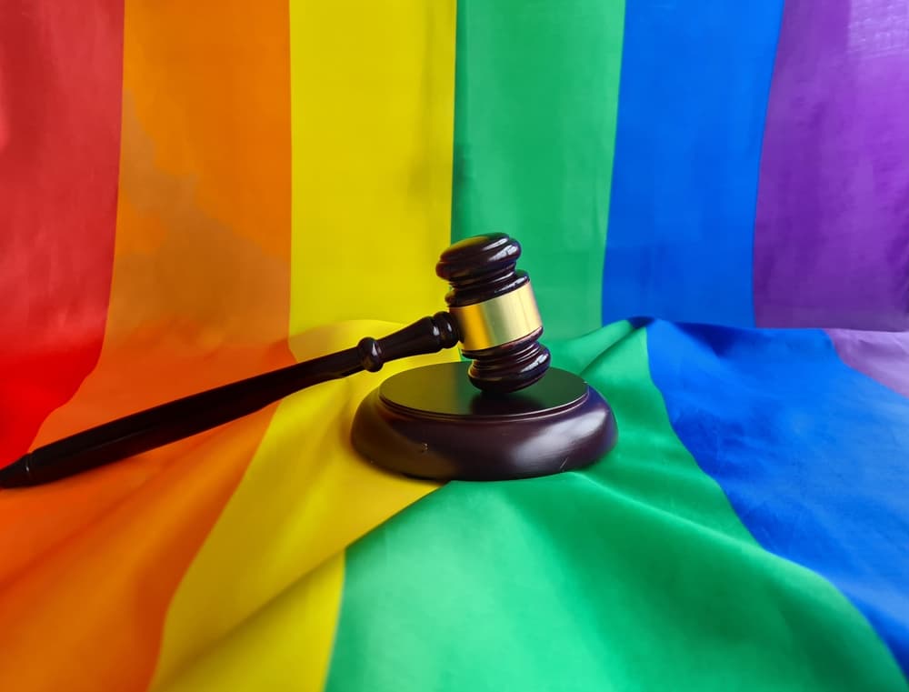 LGBTQ+ Law and Gay Marriage. Judge's gavel on rainbow flag. Banner with copy space for transgender rights.