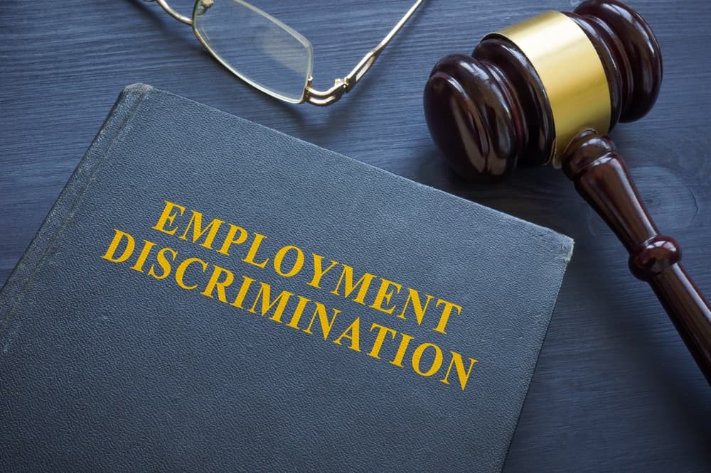 Law about employment discrimination and gavel on the table.