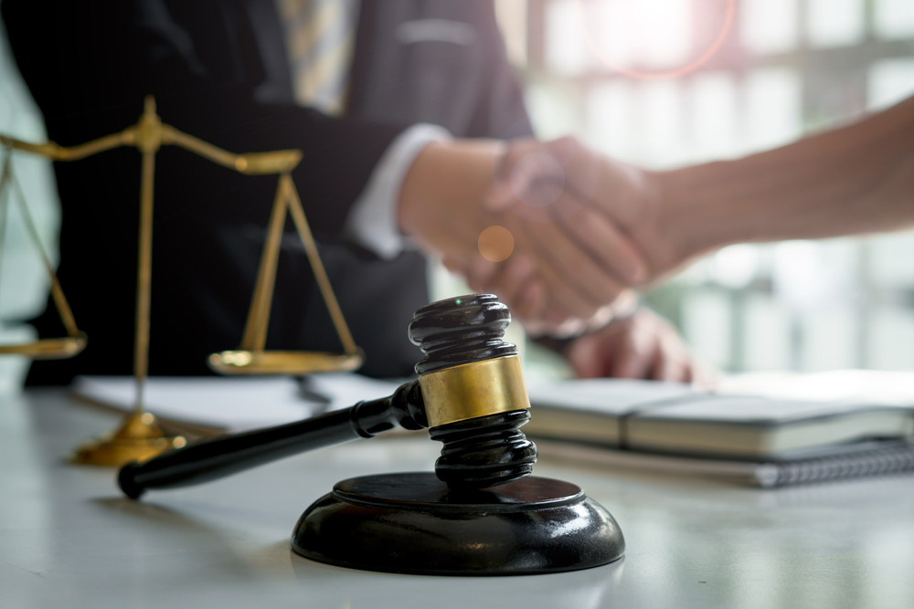 Businessman shaking hands with a lawyer or attorney after discussing a contract agreement.