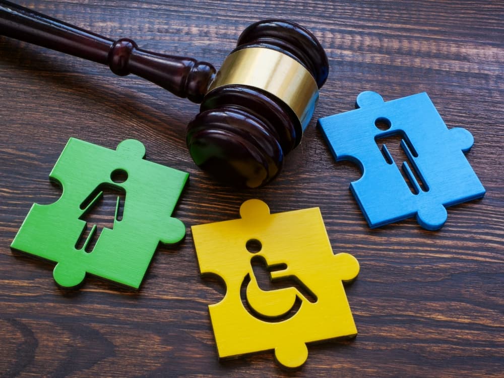 Gavel with puzzle pieces. and Disabled person sign