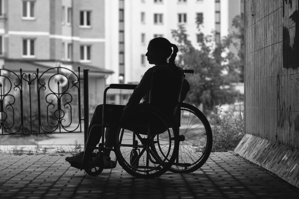 Employee in wheelchair representing disability discrimination and workplace rights in San Diego